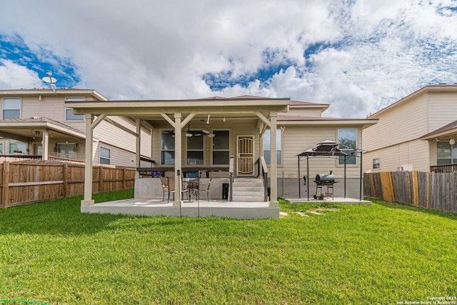 back of house with a patio and a yard