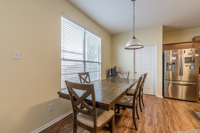 dining space featuring dark wood-type flooring