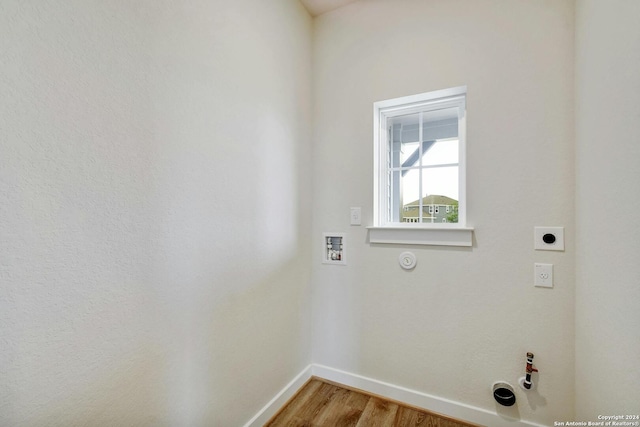 clothes washing area with electric dryer hookup, washer hookup, hookup for a gas dryer, and wood-type flooring