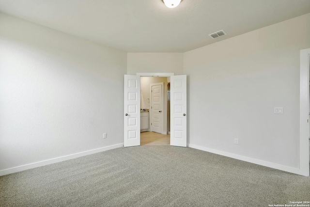 unfurnished bedroom with light carpet