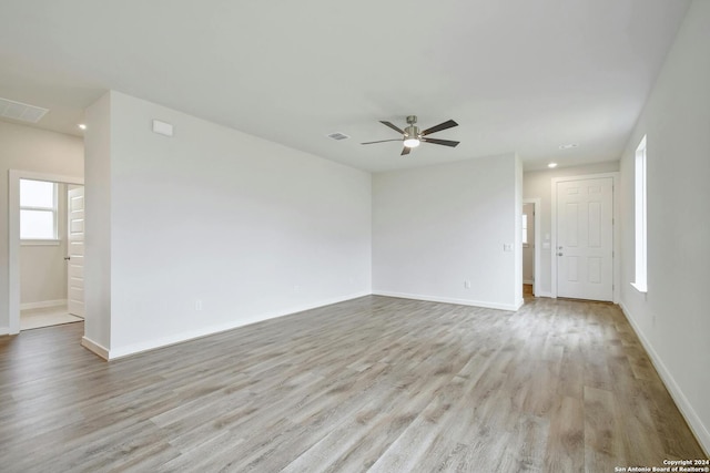 empty room with light hardwood / wood-style flooring and ceiling fan