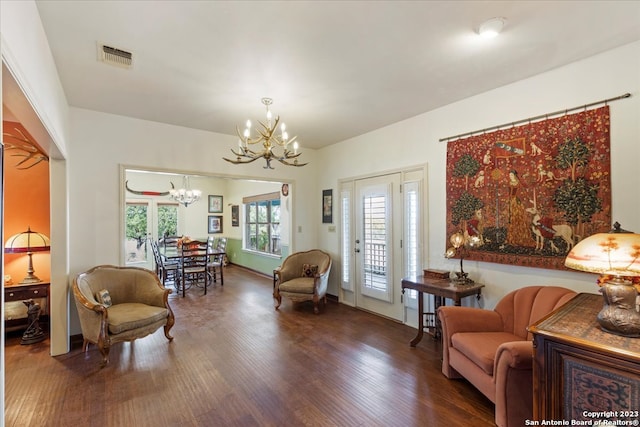 sitting room featuring dark hardwood / wood-style floors and an inviting chandelier