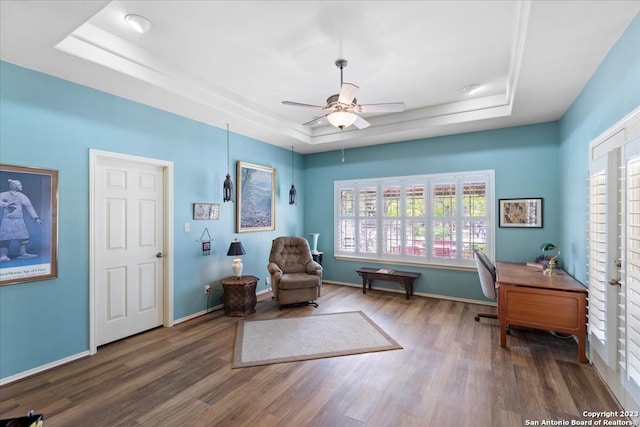 sitting room featuring french doors, ceiling fan, a raised ceiling, and dark hardwood / wood-style floors