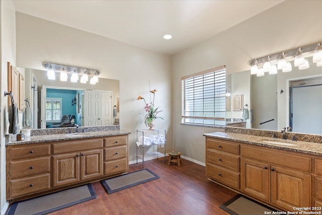 bathroom featuring double sink, oversized vanity, and hardwood / wood-style floors