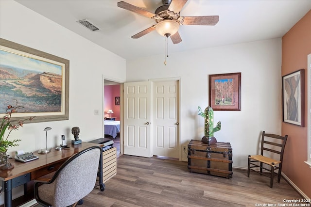 home office with dark hardwood / wood-style floors and ceiling fan