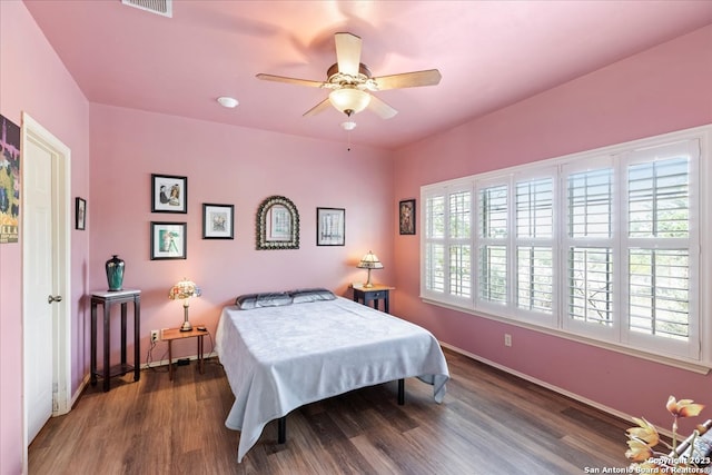 bedroom with ceiling fan and dark hardwood / wood-style flooring