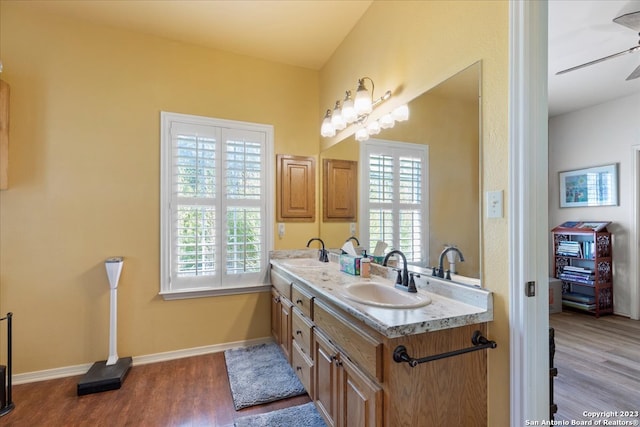 bathroom with wood-type flooring, ceiling fan, and dual vanity