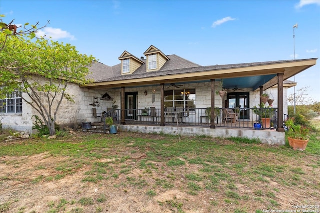 back of property with a porch