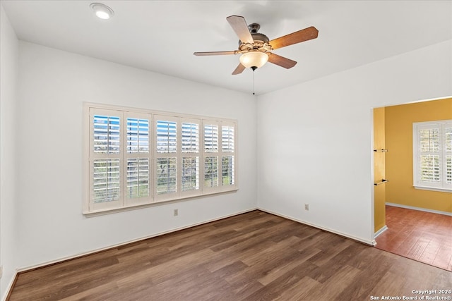 spare room with ceiling fan and dark hardwood / wood-style floors