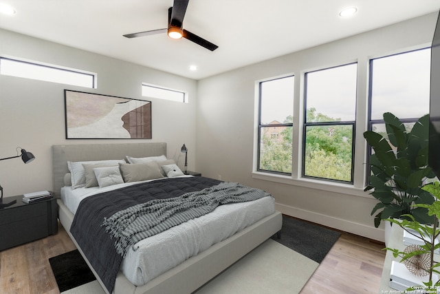 bedroom with ceiling fan and wood-type flooring