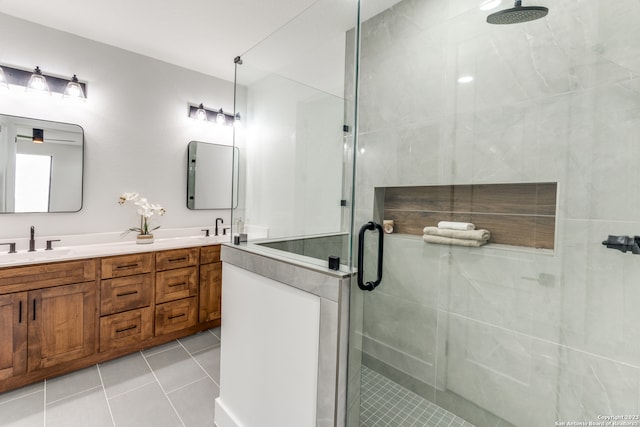 bathroom with tile patterned floors, vanity, and a shower with shower door