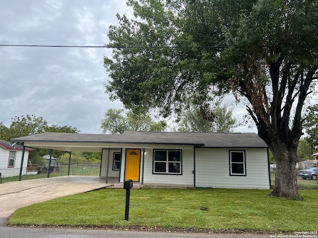 ranch-style house featuring a carport and a front lawn