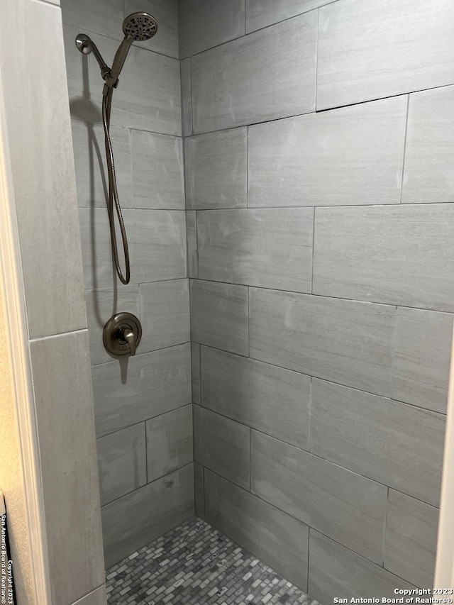 bathroom with a tile shower