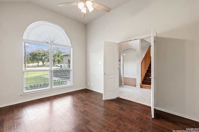 unfurnished room with a wealth of natural light, lofted ceiling, hardwood / wood-style floors, and ceiling fan