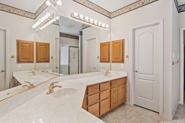 bathroom featuring vanity with extensive cabinet space, double sink, and tile flooring