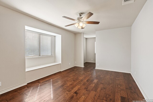 empty room with ceiling fan and dark hardwood / wood-style floors