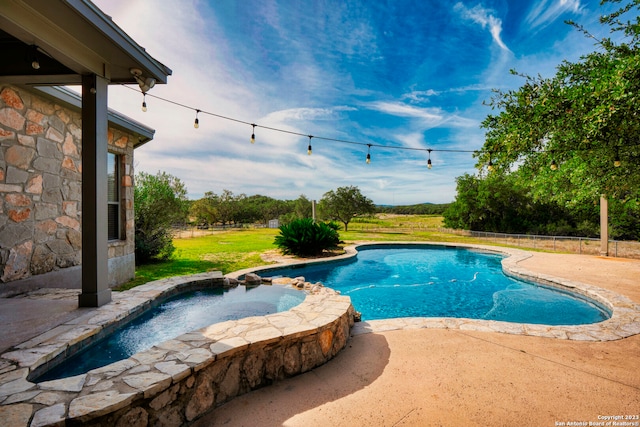 view of pool featuring an in ground hot tub and a patio area