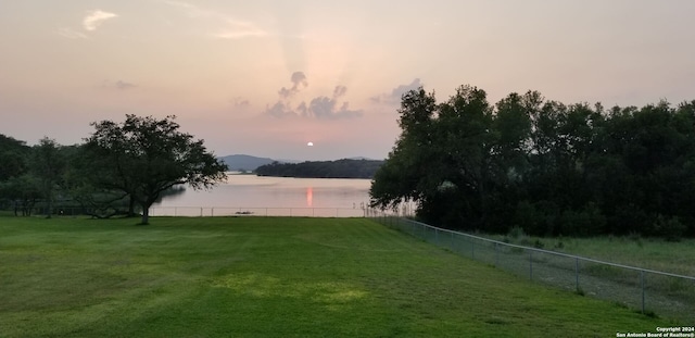 yard at dusk with a water view