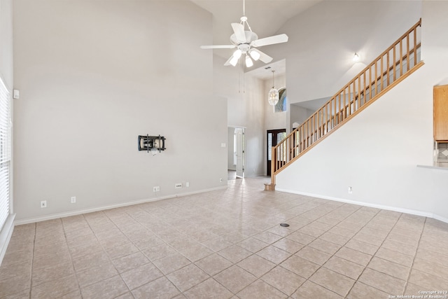 unfurnished living room featuring high vaulted ceiling, ceiling fan, and light tile floors