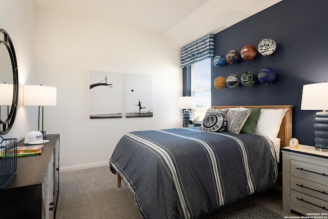 carpeted bedroom with lofted ceiling