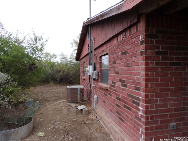 view of side of home with central AC unit