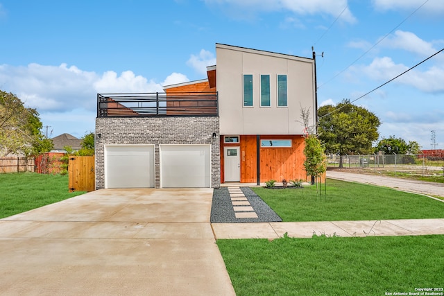 contemporary home featuring a front lawn and a garage