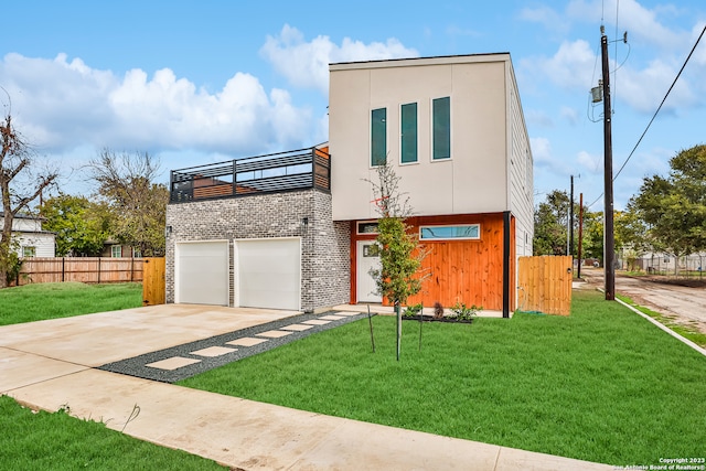 contemporary house with a front yard and a garage