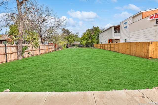 view of yard with a balcony