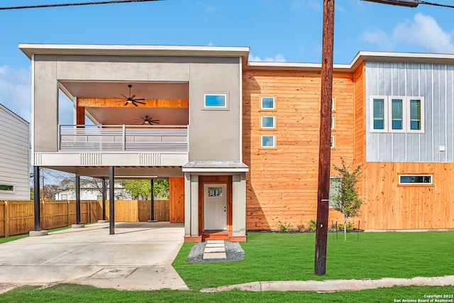 view of front of home with a front lawn and a balcony