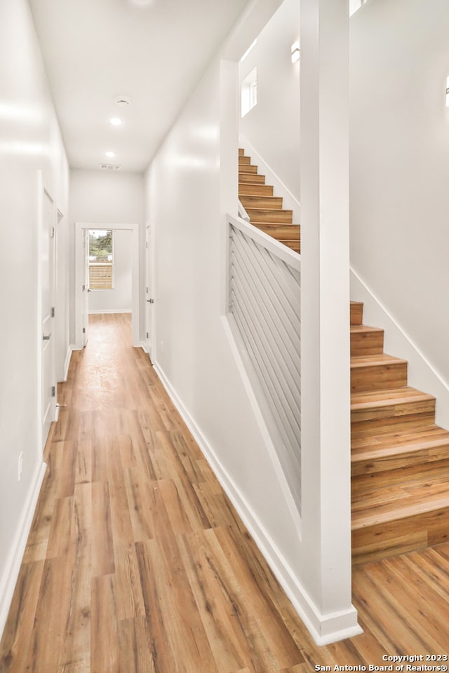 hallway with light hardwood / wood-style flooring