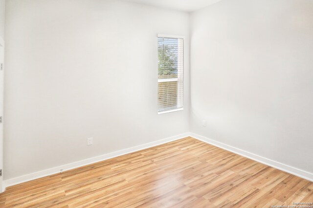 unfurnished room with light wood-type flooring