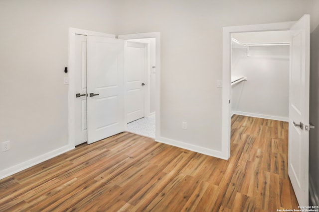 empty room with light hardwood / wood-style flooring