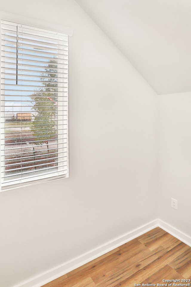 bonus room featuring vaulted ceiling and wood-type flooring