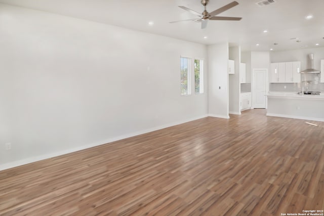 interior space featuring wood-type flooring and ceiling fan