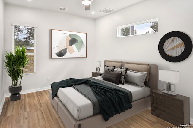 bedroom with ceiling fan and light wood-type flooring