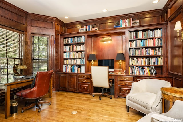 office featuring built in features and light hardwood / wood-style floors