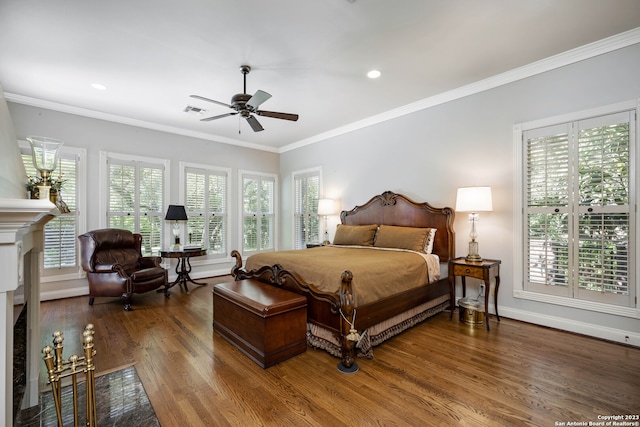 bedroom with ornamental molding, ceiling fan, and dark wood-type flooring