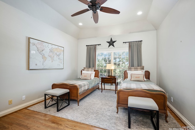 bedroom featuring lofted ceiling, light hardwood / wood-style floors, and ceiling fan