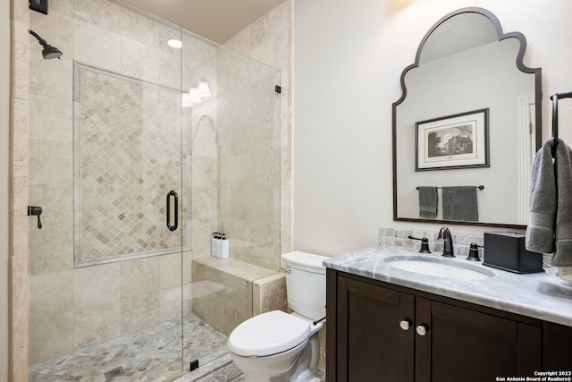 bathroom with oversized vanity, toilet, and a shower with door