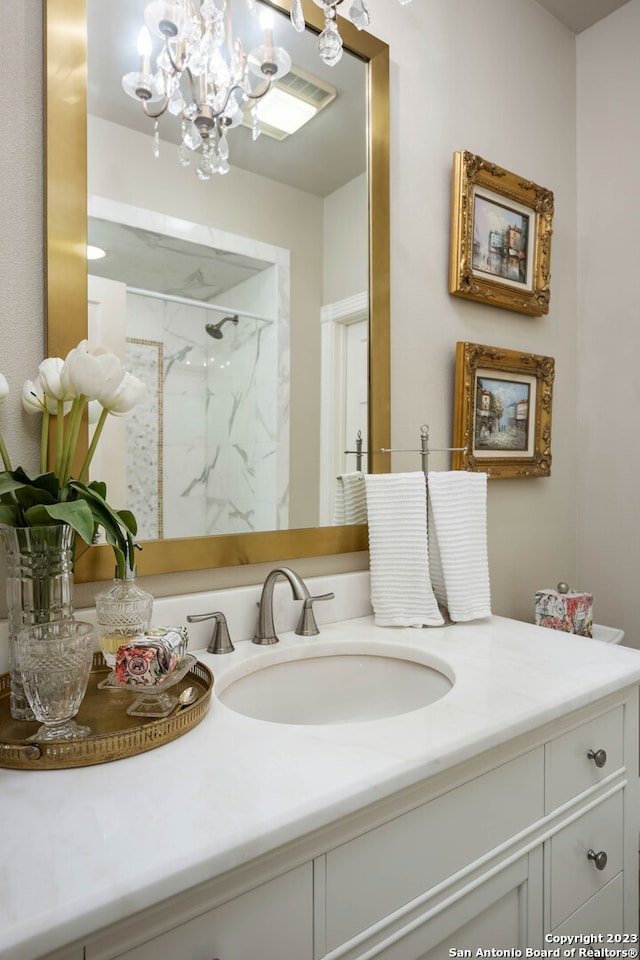 bathroom featuring vanity and a notable chandelier