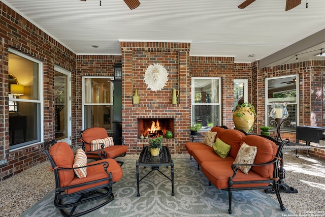 view of patio with an outdoor living space with a fireplace