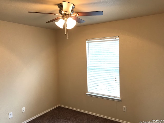 empty room with plenty of natural light, ceiling fan, and carpet floors