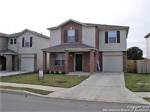 front facade with a front yard and a garage