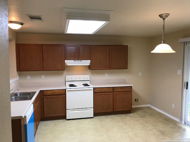 kitchen featuring pendant lighting, white appliances, sink, and light tile floors