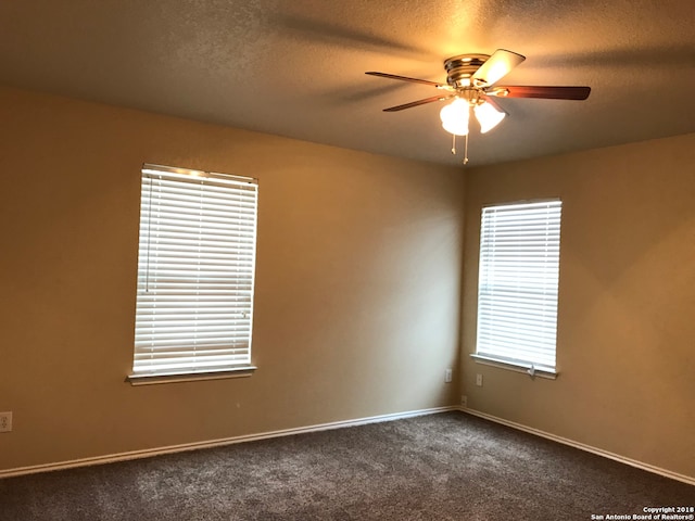 carpeted empty room featuring a textured ceiling and ceiling fan