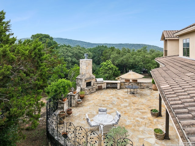 view of patio / terrace with a mountain view and grilling area