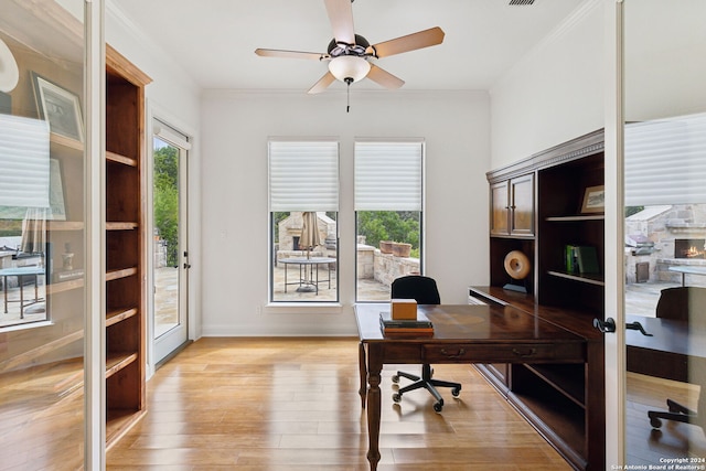 home office featuring french doors, light hardwood / wood-style floors, ceiling fan, and ornamental molding