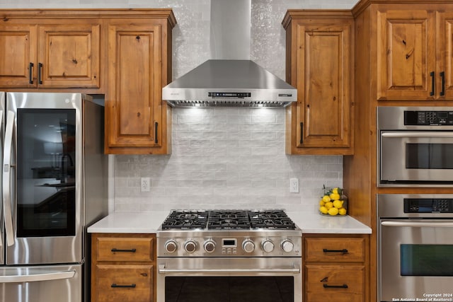 kitchen featuring backsplash, wall chimney exhaust hood, and stainless steel appliances