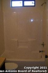 full bathroom featuring shower / washtub combination, toilet, and vanity