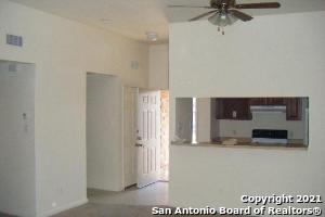 unfurnished living room featuring a high ceiling and ceiling fan